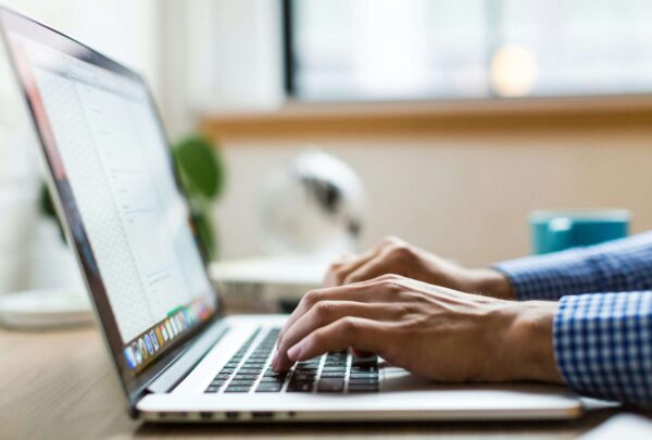 person typing on silver Macbook