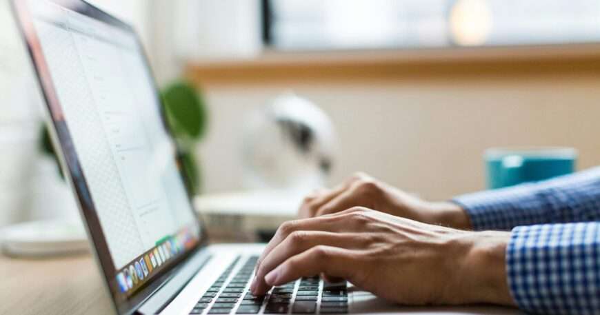 person typing on silver Macbook